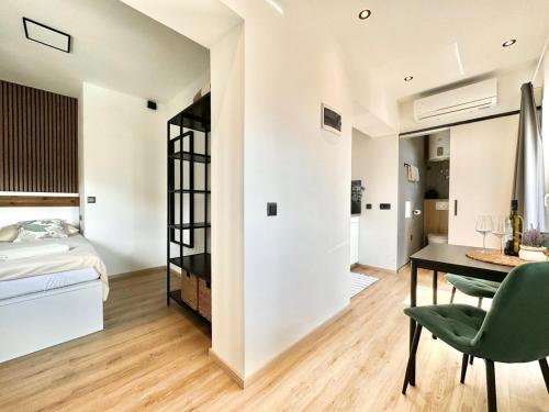 a bedroom with a bed and a desk in a room at Apartments Hajl in Krk