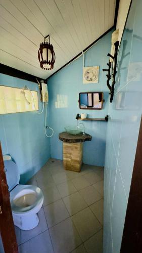 a blue bathroom with a toilet and a sink at Kinnaree Resort Koh Kood in Ko Kood