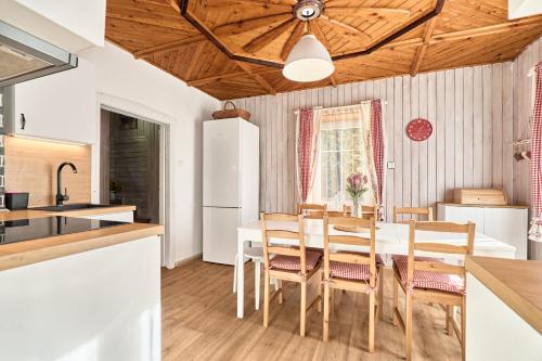 a kitchen and dining room with a table and chairs at Chalupa pod stromy in Kovářská
