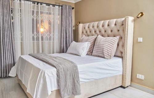 Ένα ή περισσότερα κρεβάτια σε δωμάτιο στο Mawi Homes