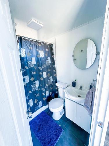 Un baño con inodoro, lavabo y espejo. en Cabañas del Sol, en La Boca