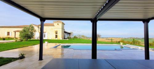 a view from the patio of a house with a swimming pool at La Colline Gersoise-Piscine-Sauna in La Sauvetat