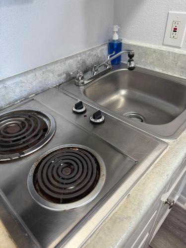 a stainless steel kitchen sink with a stove at Ocean & Pool View - Hot Tub - 2 Pools - Gym - Tennis ct - Shoreline Stays 10 in Galveston