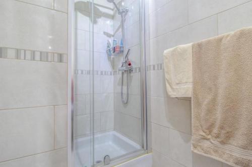 a shower with a glass door in a bathroom at Costa Arenal 54 in Arenal d'en Castell