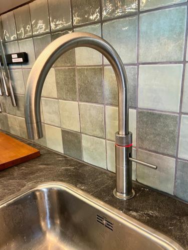 a kitchen sink with a faucet on a counter at The Cozy Nest in Arnhem