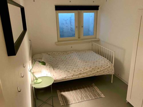 a small bedroom with a bed and a window at The Cozy Nest in Arnhem
