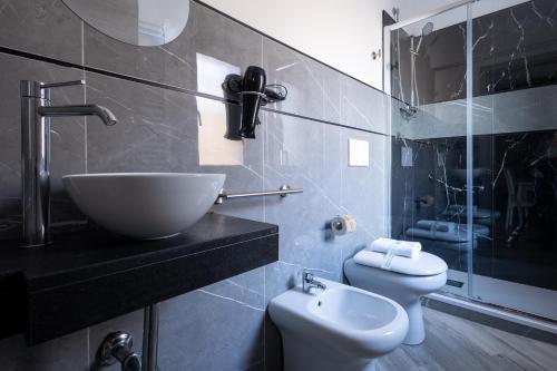 a bathroom with a sink and a toilet at Il Piccolo Borghetto in Rome