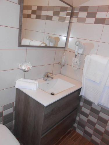 a bathroom with a sink and a mirror at B&B Paradiso in Falerna