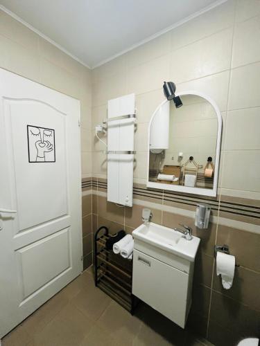 a bathroom with a sink and a mirror at Race for Space in Niš