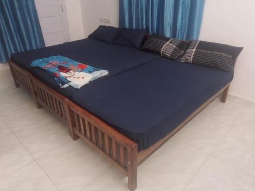 a bed in a room with a blue mattress at Dev And Ganga Homes in Trichūr
