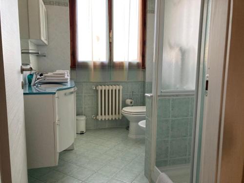 a bathroom with a toilet and a sink and a window at La Culla del Mugello in Scarperia