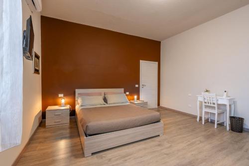 a bedroom with a bed and a table and a desk at La Culla del Mugello in Scarperia