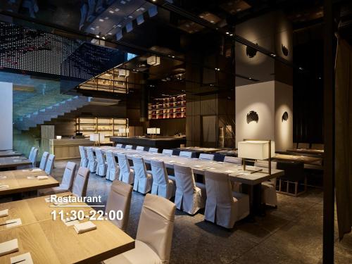 a restaurant with rows of tables and chairs at Millennium Mitsui Garden Hotel Tokyo - Ginza in Tokyo