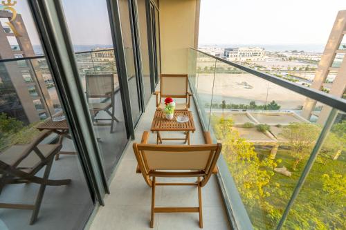 a balcony with a table and chairs in a building at Modern 1BR Oasis - Sleek Chic Retreat in Abu Dhabi