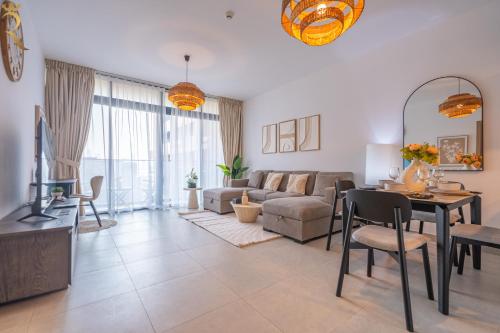 a living room with a couch and a table at Modern 1BR Oasis - Sleek Chic Retreat in Abu Dhabi