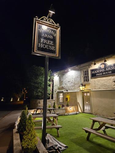 a sign for a fireside fire house in front of a building at The Masons Arms in Harrogate