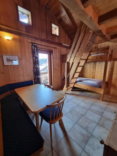 a dining room with a table and a bunk bed at Wieshof Schnals Bauernhofurlaub in Maso Corto