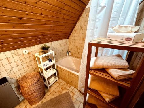 Un baño pequeño con bañera y lavabo. en Ferienwohnung zum Woibauer, en Deidesheim