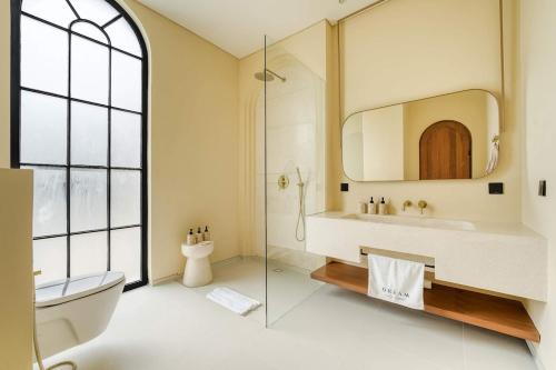 a bathroom with a sink and a toilet and a mirror at Parisian 2BR Luxury Villa 8mins walk to Beach in Bingin Beach