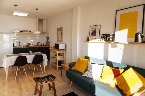 a living room with a blue couch and a table at HORIA -Sundrenched apartment with terrace in Cabo de Gata in El Pozo de los Frailes