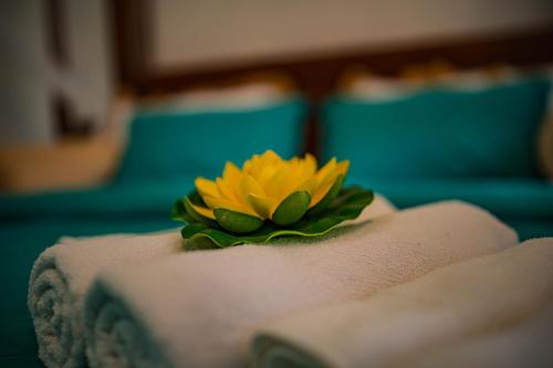 a yellow flower sitting on top of a book at ROYAL CREST VILLA in Weligama