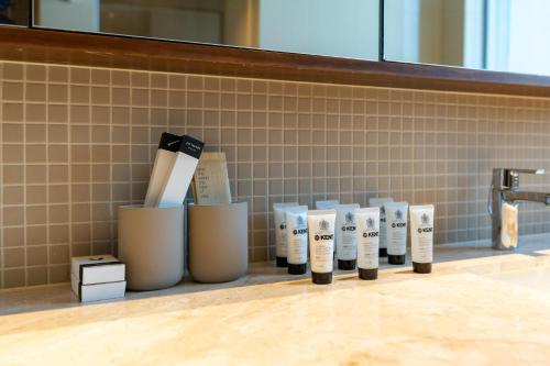 a row of four bottles of hair products in a bathroom at Boulevard Point I Burj Khalifa Fireworks View in Dubai