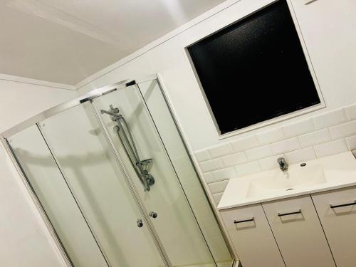 a bathroom with a shower and a sink at Mount Breeze in Mount Maunganui