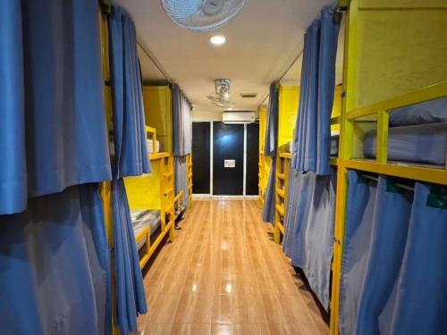 a corridor of a bus with bunk beds and a hallway at Easy Hostel in Phi Phi Don