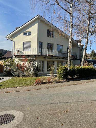 a white house on the side of a street at Your exclusive holiday home in Winterthur