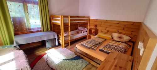 a bedroom with two bunk beds and a fireplace at Apartmán Kienberg pod Lipenskou hrází in Lipno nad Vltavou