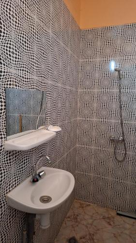 a bathroom with a sink and a shower at Jalila House in Aourir