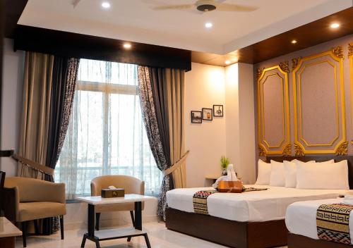 Ένα ή περισσότερα κρεβάτια σε δωμάτιο στο Ambrina Hotel