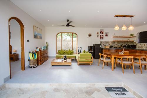a living room with a table and a dining room at Bukti Garden Villas in Bukti