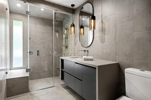 a bathroom with a sink and a shower at Tranquill 4BR Retreat in Sassafras