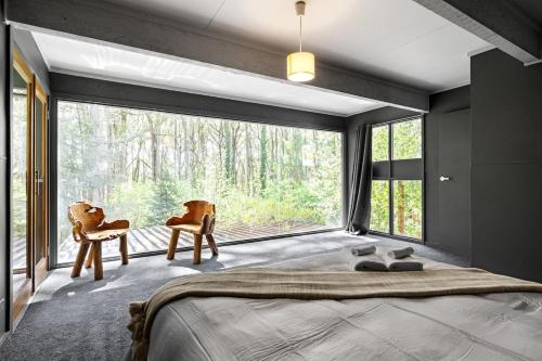 a bedroom with a bed and a large window at Tranquill 4BR Retreat in Sassafras