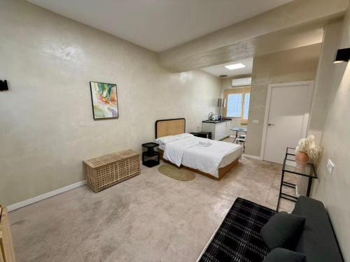 a bedroom with a bed and a living room at Suite N25 in Madrid