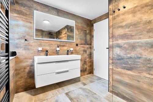 a bathroom with a white sink and a mirror at Apartment K&L Boží Dar in Boží Dar