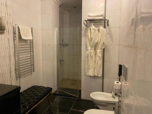 a bathroom with a shower and a toilet and a sink at Lake view Palace Hotel in Baku