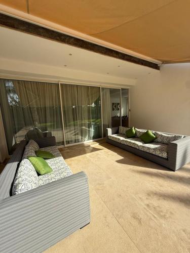 two beds in a room with green pillows at Villa 9- luxurious 5 bedrooms villa in the heart of Ambassadors in Rabat