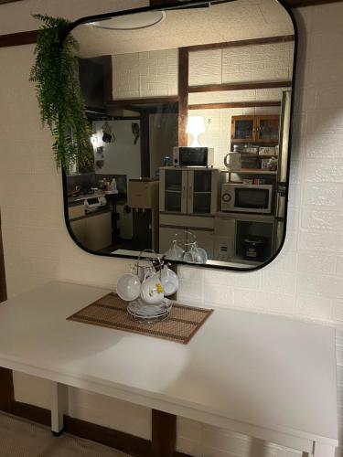 a mirror reflection of a kitchen in a room at One room Pusang Gala Yuki City in Yuki