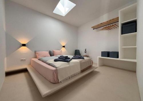 a bedroom with a large bed and a tv at casamujeres in Punta de Mujeres