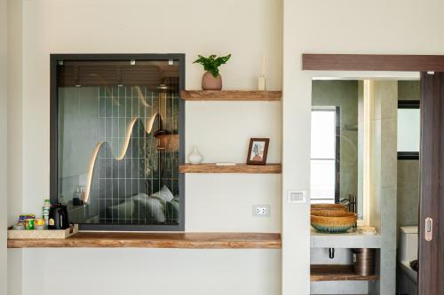 a room with a glass door with a living room at naravi gardenandpool kohlarn in Ko Sak