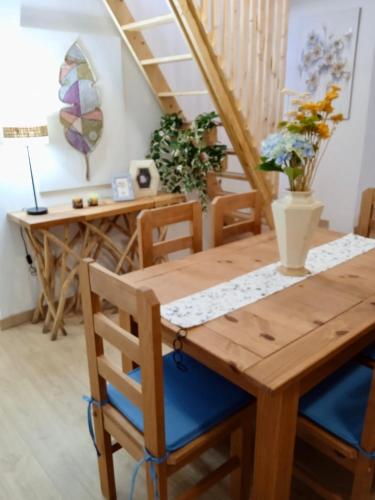 a dining room with a wooden table and chairs at La Esperanza Apartaments in La Esperanza