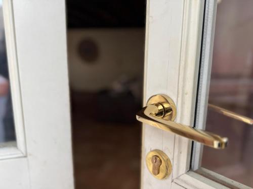 a door with a brass door knob on a white door at Dimora Sant'Anna Family Suite in Bernalda