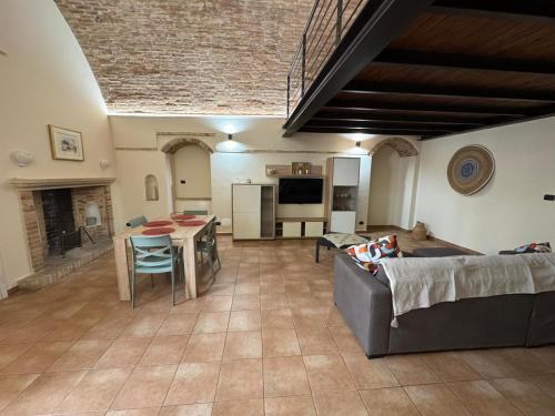 a living room with a couch and a table at Dimora Sant'Anna Family Suite in Bernalda