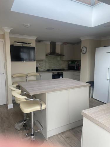 a kitchen with white cabinets and a white counter top at Cozy En-suit by nec & airport in Marston Green