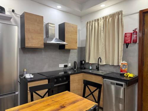 a kitchen with a sink and a stove top oven at 4 Bed Maisonette Close to Mater Dei in Birkirkara