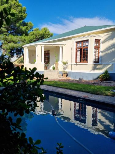 a house with a swimming pool in front of it at Serene Haven Guest House in Victoria West