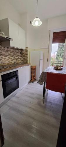 a kitchen with a table and a stove top oven at Raggio di Sole in Loano