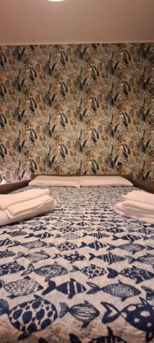 a bedroom with a bed with a bird wallpaper at Raggio di Sole in Loano